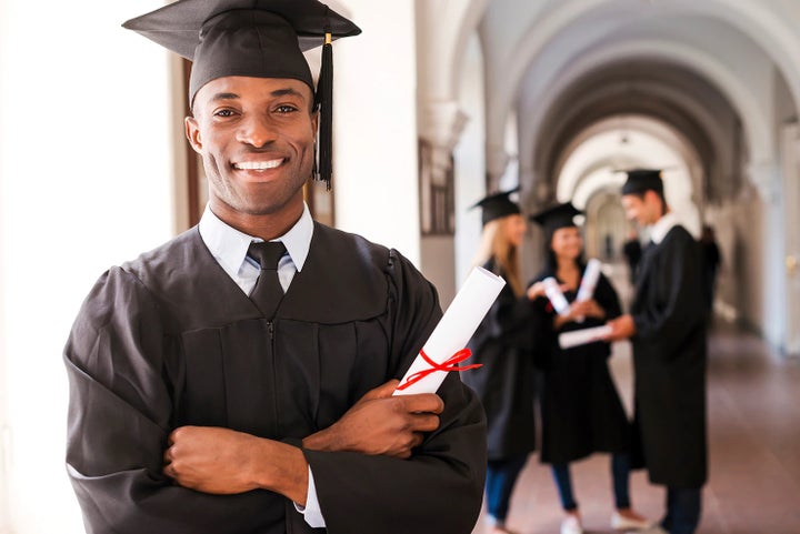 college graduate holding his diploma | Great Lakes Subaru in Findlay OH