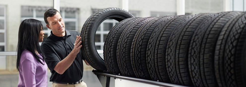 Subaru service representative showing customer a tire. | Great Lakes Subaru in Findlay OH