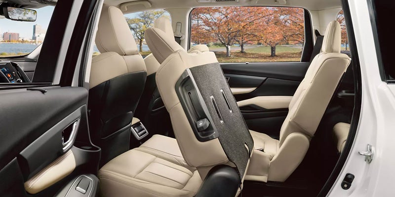 Vehicle interior showing beige third-row seating