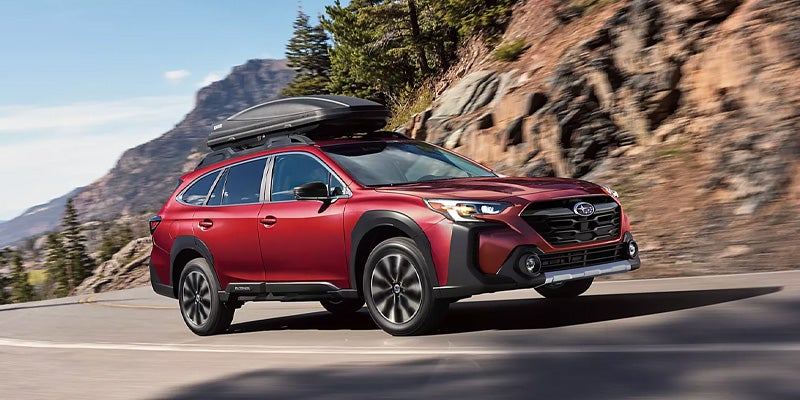 Blue Subaru SUV driving on rough road